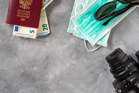 Medical mask and international Polish passport. Travel concept, tourism care, corona virus disease.の写真素材