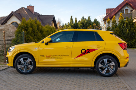 Gdansk, Poland - April 20, 2020: Yellow Audi Q2 car parked on street