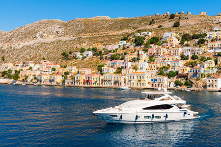 SYMI, GREECE - May 15, 2018: Luxury boat in sea bay scene. Coast of the island of Symi. Greece