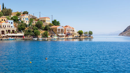 SYMI, GREECE - May 15, 2018: Clock tower in harbor of Symi island, Dodecanese, Greece
