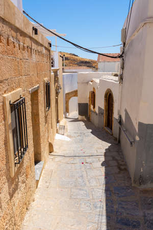 Old narrow street in Lindos village on Rhodes island. Dodecanese, Greece.の写真素材