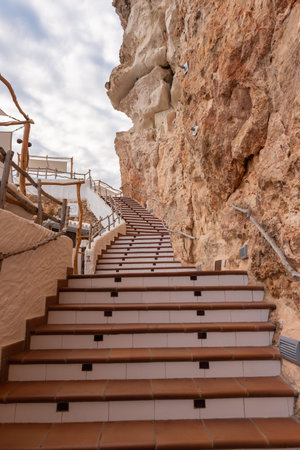 Menorca, Spain - October 14, 2019: Stairs leading to a hidden coffee bar in caves in Menorca, Spainのeditorial素材