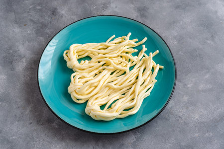 Braided cheese pigtail. Traditional polish salty string cheese