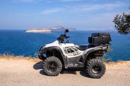 Santorini, Greece - September 16, 2020: Quad bike parked on the seafront in Akrotiri village on Santorini islandのeditorial素材