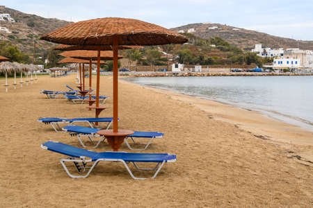Ios, Greece - September 19, 2020: Beach loungers with umbrellas on sandy beach of Chora on Ios Island. Cyclades, Greeceのeditorial素材