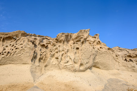 Bright cliffs formed by a volcano at Vlychada Beach, also known as the Moon Beach. Southern part of...