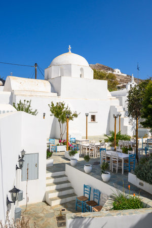 Small square with church building on street in beautiful Chora town on Folegandros Island, Cyclades,...