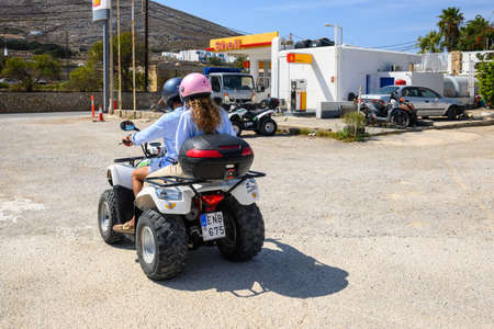 Folegandros, Greece - September 23, 2020: Young couple driving quad bike on Folegandros Island. Cyclades, Greeceのeditorial素材