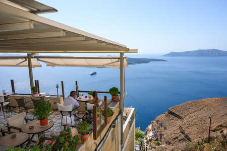 Santorini Greece, September 17, 2020: Greek seafront restaurant in Fira on Santorini Island. Cyclades, Greeceのeditorial素材