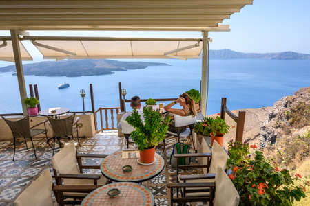 Santorini Greece, September 17, 2020: Greek seafront restaurant in Fira on Santorini Island. Cyclades, Greeceのeditorial素材