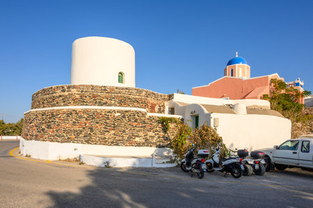 Santorini Greece, September 17, 2020: White old windmill and Agios Sostis church in Oia on Santorini Island. Greeceのeditorial素材