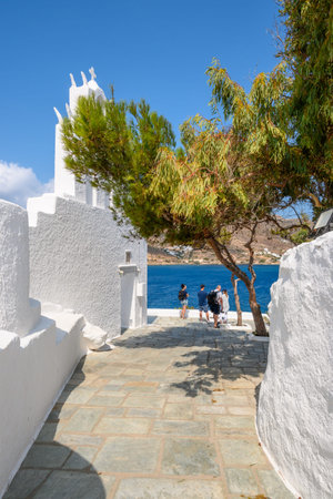 Ios, Greece - September 22, 2020: Tourists visit the church of Agia Irini (Saint Irene) near the port of Ios. Cyclades, Greeceのeditorial素材
