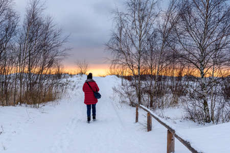 Jastarnia, Poland - January 17, 2021: The woman walks a snowy path to the beach in Jastarnia on the Hel Peninsula.のeditorial素材
