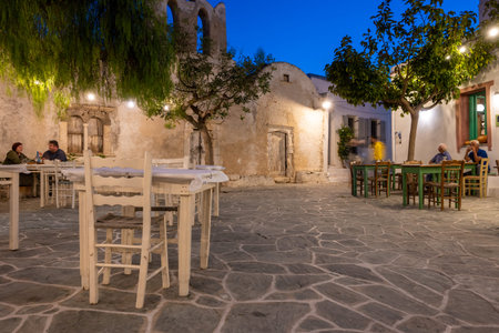 Folegandros, Greece - September 23, 2020: Small square with old church and restaurants in Chora on Folegandros Island at night. Cyclades, Greeceのeditorial素材