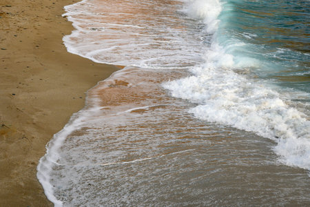 Foaming waves of turquoise sea water on an exotic beach.