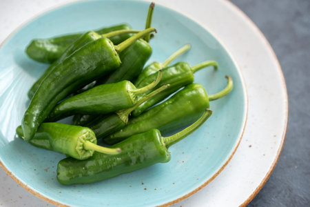 Group of green fresh chilli peppers padron on a plate