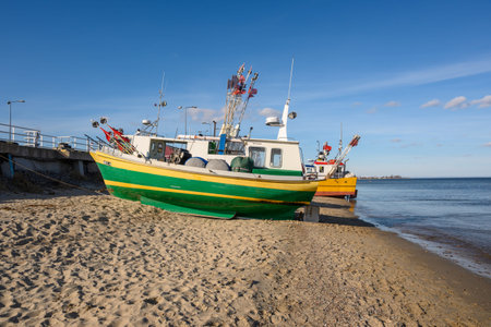 Mechelinki, Poland - March 6, 2021: Fishing boats on the beach in Mechalinki. Mechelinki is a...
