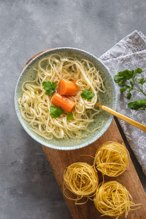 Turkey and beef broth with noodles in a bowlの写真素材