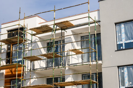 Gdansk, Poland - April 11, 2021: Construction scaffolding of a modern apartment building under construction.のeditorial素材