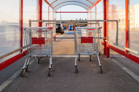 Shopping trolleys standing in row near hypermarket.