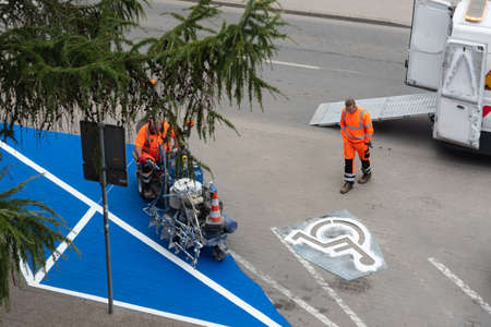 Gdansk, Poland - October 6, 2021: Painting road sign parking space for disabled peopleのeditorial素材