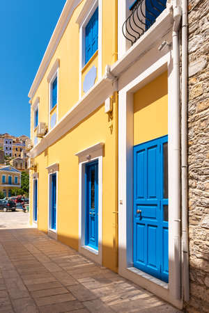Greek house with blue door and window on Symi island in Greeceの写真素材