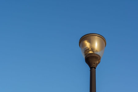 Street lantern, electric lighting. Lamp on background of blue sky.