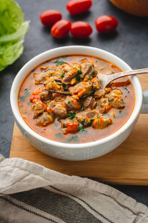 Chicken stomachs stewed in tomato sauce with vegetables
