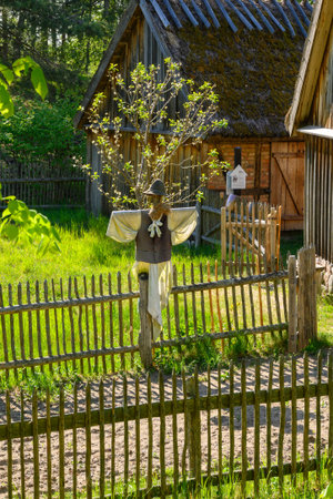 Wdzydze Kiszewskie, Poland - May 15, 2022: scarecrow in the garden. Kashubian Ethnographic Park in Wdzydze Kiszewskieのeditorial素材