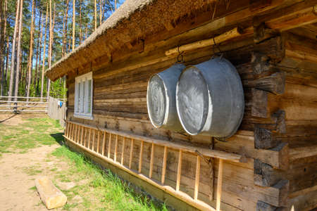 Wdzydze Kiszewskie, Poland - May 15, 2022: Household tools, wooden hut. Kashubian Ethnographic Park in Wdzydze Kiszewskie. Polandのeditorial素材