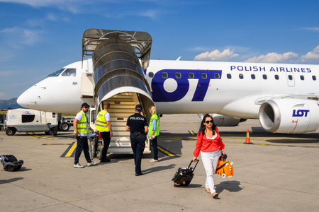 Podgorica, Montenegro - June 3, 2022: Passengers disembark from the passenger plane of the Polish...