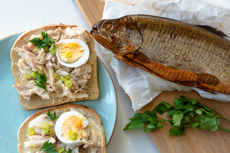 Sandwich with smoked trout and egg for breakfastの写真素材