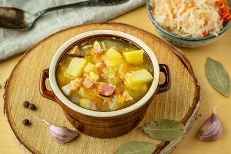 Sauerkraut soup with potatoes, carrots and bacon. Soup with cabbageの写真素材
