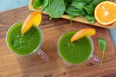 Fresh spinach, banana and orange fruit smoothie. Detox green drinkの写真素材