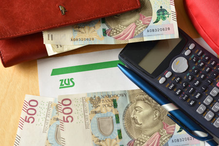 Gdansk, Poland - May 3, 2023: ZUS (National Social Insurance Company) logo on a sheet of paper and polish moneyのeditorial素材