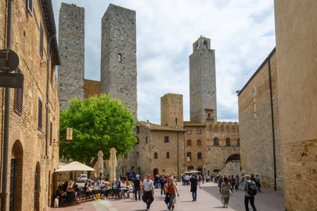 San Gimignano, Italy - April 30, 2023: Tourists visiting the Old Town of San Gimignano. The town is famous for its medieval architectureのeditorial素材
