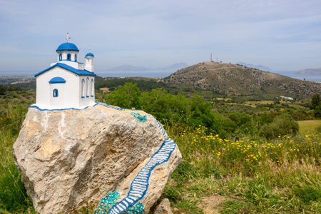 Small white blue church on a rock near village of Zia on the island Kos in Greeceの写真素材