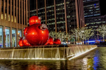 New York City, NY / USA - 12 23 2013: Red Christmas Balls installation for Christmas decoration of the Sixth Avenue in New York over a pool of water, Christmas tree lightings, decoration in Manhattan.のeditorial素材
