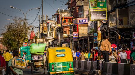 New Delhi / India - April 12 2017: Busy street Chandni Chowk in Old Delhi downtown area with crowds of people, yellow rickshaws. The busiest market in the world. Typical Delhi, India.のeditorial素材