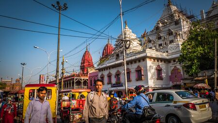 New Delhi / India - April 11 2017: White and red stone temples at Chandni Chowk busiest street and market in New Delhi. Crowds of people with yellow rickshaws downtown Delhi, India.のeditorial素材