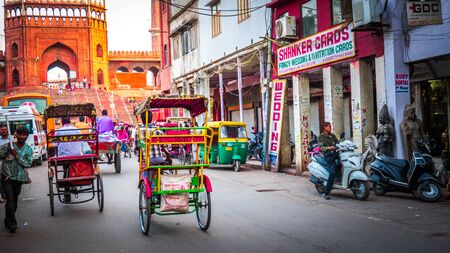 New Delhi / India - April 11 2017: Busy market street, bazaar in the old part of New Delhi in India next toe the Jama Masjid entrance gate. Rickshaws on a busy street downtown New Delhi.のeditorial素材