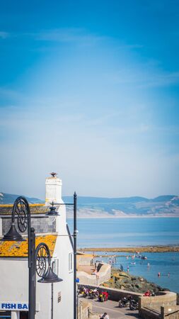 Lyme Regis, Dorset / UK - 08 29 2017: View of Lyme Regis holidays bay from the Lyme Regis town with shell shaped Street light on Jurassic coast, Dorset, at English Channel in the United Kingdom, UK.のeditorial素材