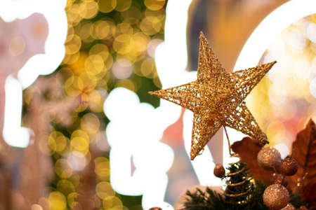 Decorated brown Christmas tree, sparkling and fairy background with color ballの写真素材