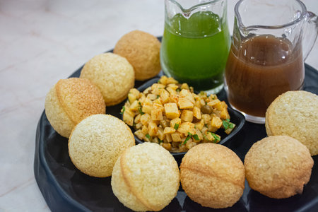 This picture is Indian food made in Thailand. It is served with two colors of sour sauce.の写真素材