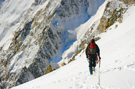 Mountaineer sport  A climber reaching the summit of the mountain
