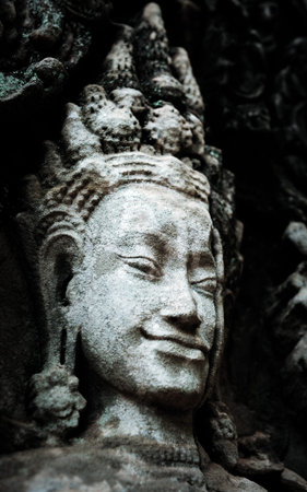 Statue of woman on the wall in ancient temple in Thailand. Concept of buddhism. Religion concept
