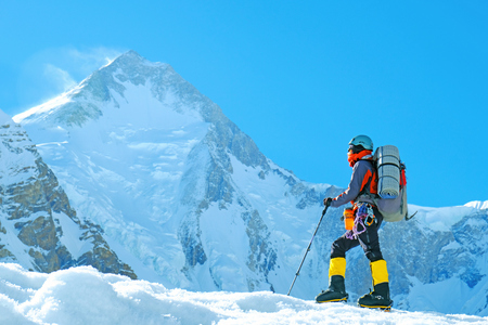Group of climbers reaches the summit of mountain peak. Success, freedom and happiness, achievement in mountains. Climbing sport concept.の写真素材