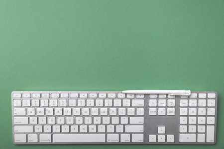 white keyboard on green background.の写真素材