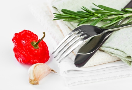 bowl with the tomatoes with a knife and fork on a white backgroundの写真素材