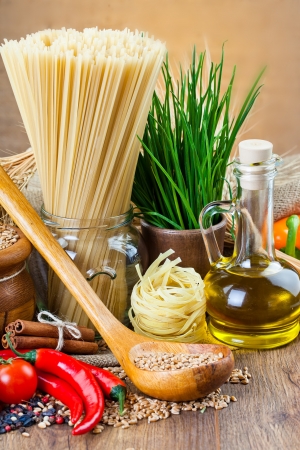 The composition of the pasta and vegetables on background の写真素材
